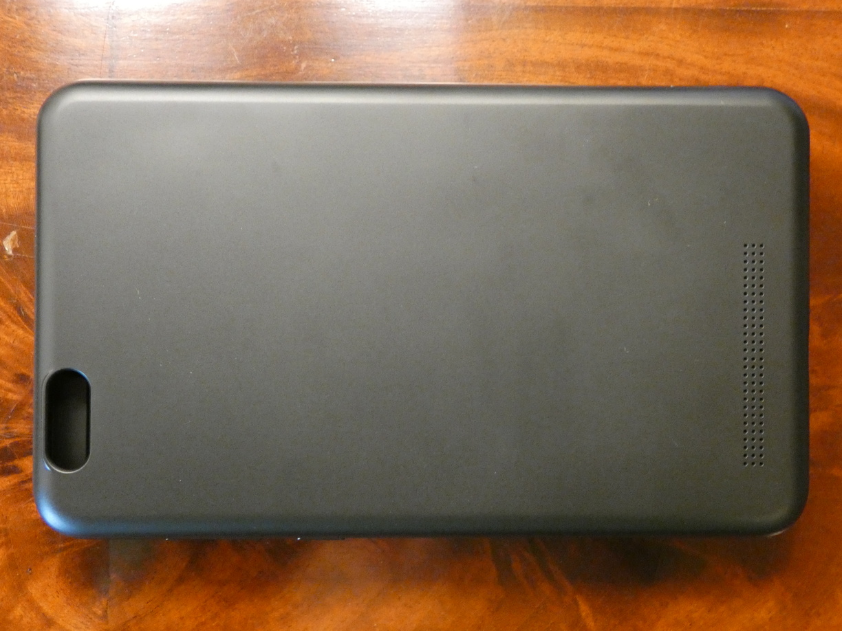 A photo of the empty closed keyboard case from above. It’s just a rounded rectangle with a big hole for the camera and a strip of small holes for the speaker.