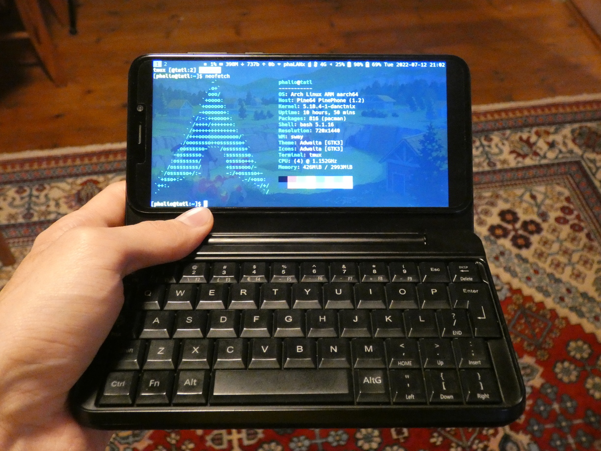 A photo of the powered-on device just like in the last image, but this time held by my left hand.